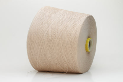 Close-up of a vibrant, Powder Pink Beige cotton yarn. The smooth, tightly twisted 2-ply thread exhibits a subtle sheen and deep, saturated color.