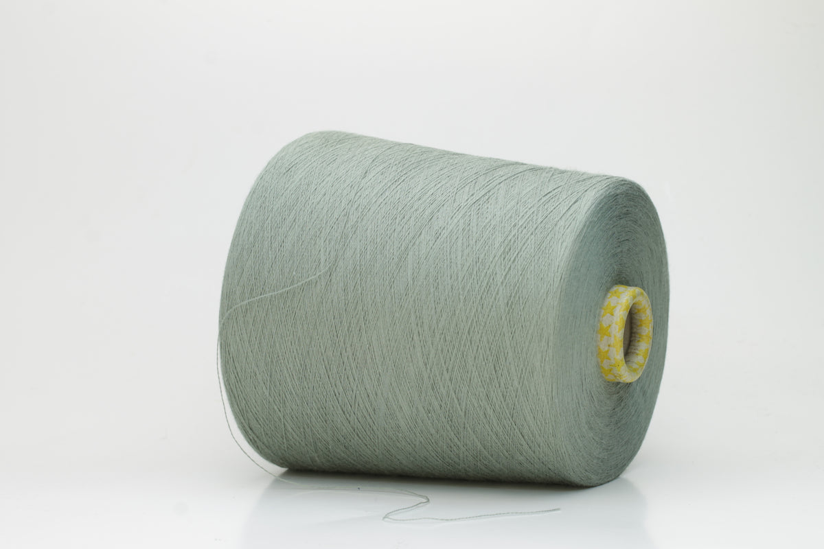 Close-up of a finely twisted Nm 2/50 cotton yarn in a muted, sophisticated sage green heather, exhibiting a subtle matte sheen and uniform ply.