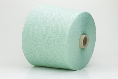 A finely spun, smooth cotton yarn in a delicate pastel mint green color, showing a subtle sheen and tightly plied structure.