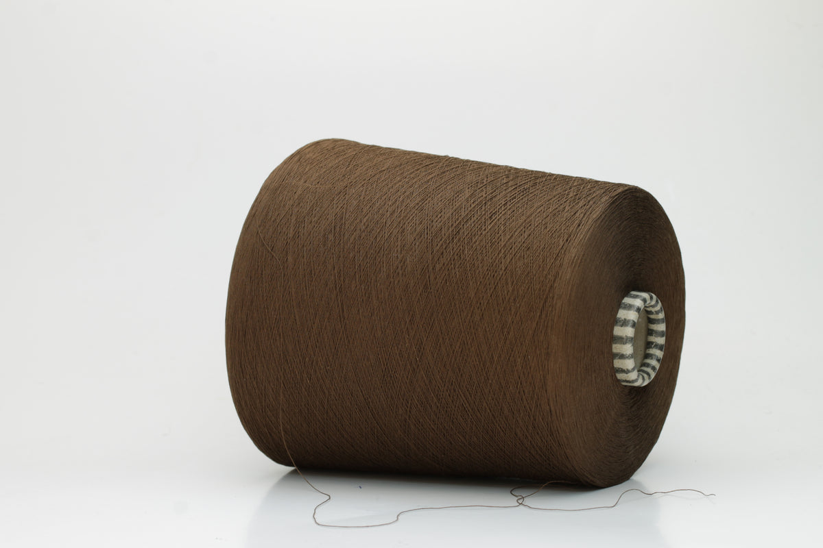 Smooth, tightly twisted two-ply cotton yarn in a rich, warm chestnut brown. Displays a subtle sheen and fine, even thread structure.