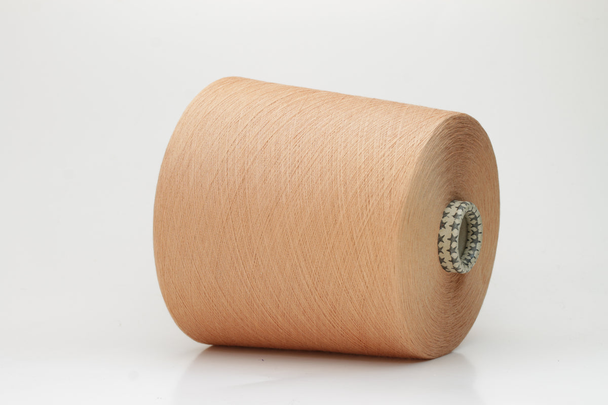 Close-up of finely spun Warm Peach Beige 100% cotton yarn, exhibiting a soft, matte sheen and a gentle two-ply twist. The sophisticated blend of khaki and beige fibers creates a nuanced, earthy tone.