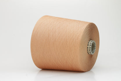 Close-up of finely spun Warm Peach Beige 100% cotton yarn, exhibiting a soft, matte sheen and a gentle two-ply twist. The sophisticated blend of khaki and beige fibers creates a nuanced, earthy tone.
