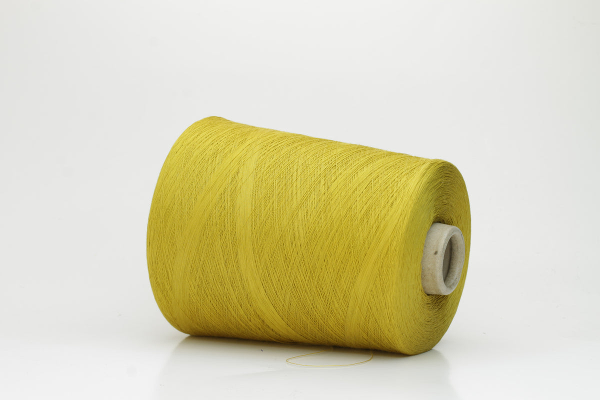 Close-up of tightly plied 100% cotton yarn in a vivid chartreuse yellow, displaying a subtle sheen and consistent twist.