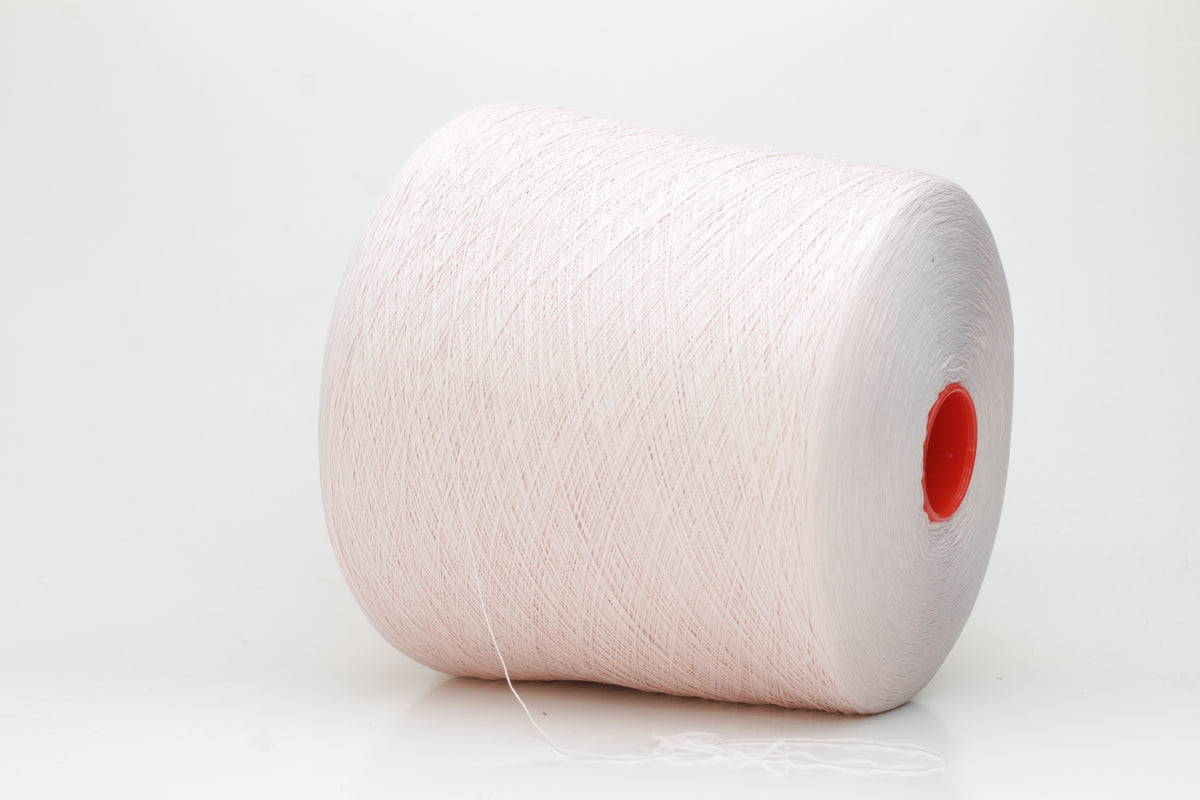 Close-up of a smooth, twisted, three-ply premium nylon yarn in a soft, elegant rose pink shade, exhibiting a subtle sheen and consistent strand structure.