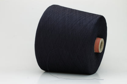 A skein of finely spun, smooth 100% cotton yarn in a deep Midnight Navy, showing a subtle sheen and even, uniform twist.