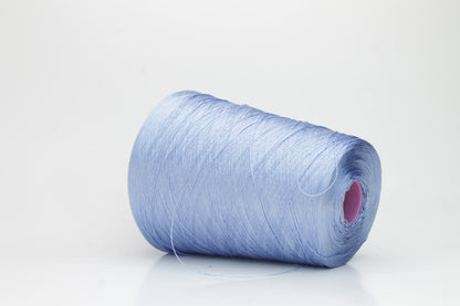 Close-up of extremely fine, single-ply pure silk yarn in a pale, iridescent sky blue. It has a high natural sheen and smooth, uniform texture.