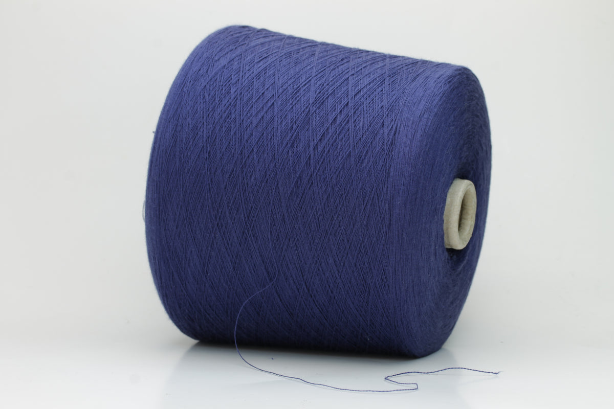 Finely twisted 2-ply cotton yarn in a rich, deep cornflower blue shade, showing a smooth, even texture and subtle natural sheen.