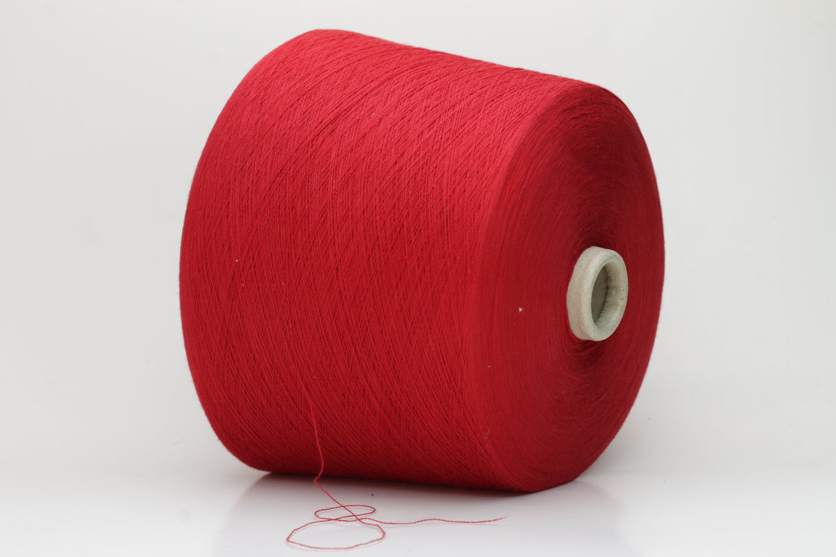Close-up of a vibrant, rich red cotton yarn. The smooth, tightly twisted 2-ply thread exhibits a subtle sheen and deep, saturated color.