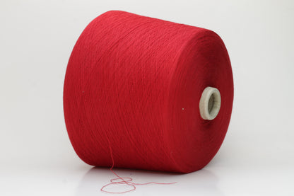 Close-up of a vibrant, rich red cotton yarn. The smooth, tightly twisted 2-ply thread exhibits a subtle sheen and deep, saturated color.