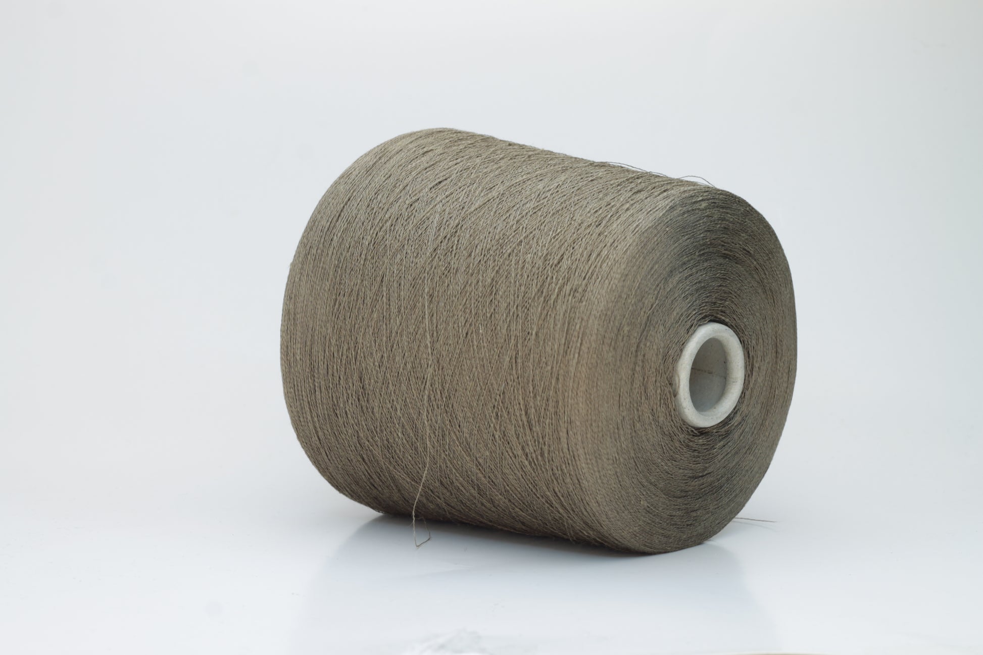A single-ply yarn in a rich, warm 'Castoro' earthy brown. It has a slightly textured, natural linen look with a subtle sheen, wound loosely.