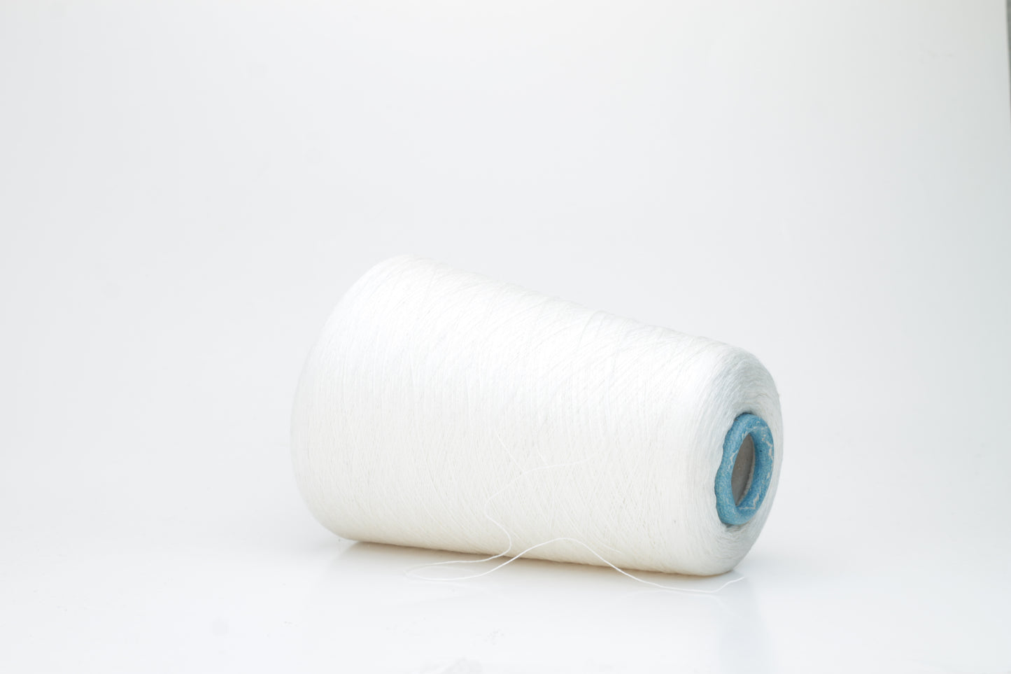 Fine, pure white silk yarn, tightly twisted with a subtle, radiant sheen. Smooth texture, uniform ply, elegant thread structure for delicate projects.