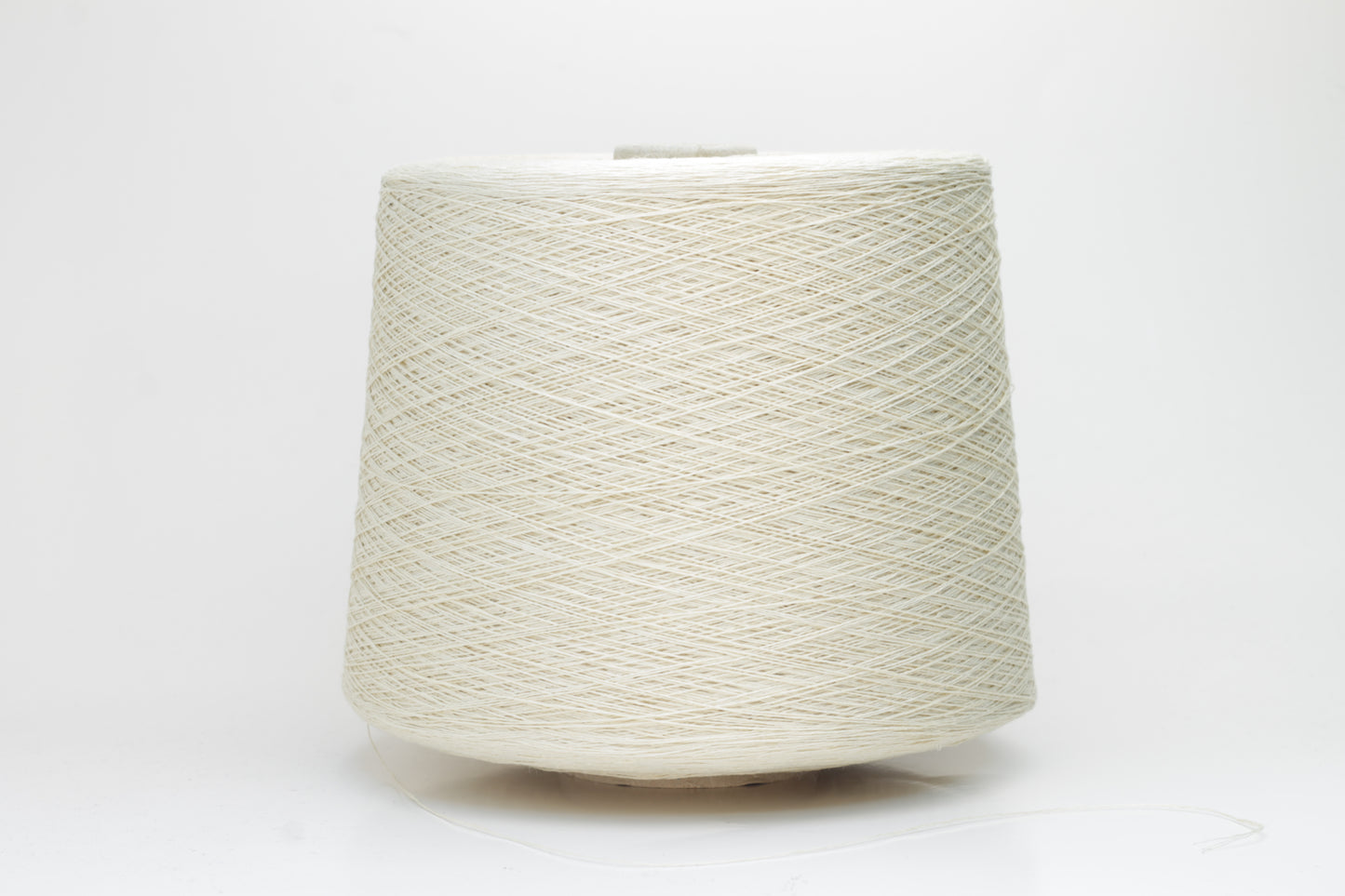 A soft light beige three-ply linen yarn, tightly twisted with a subtle natural sheen, presented in a neatly wound skein, showcasing its crisp, cool texture.