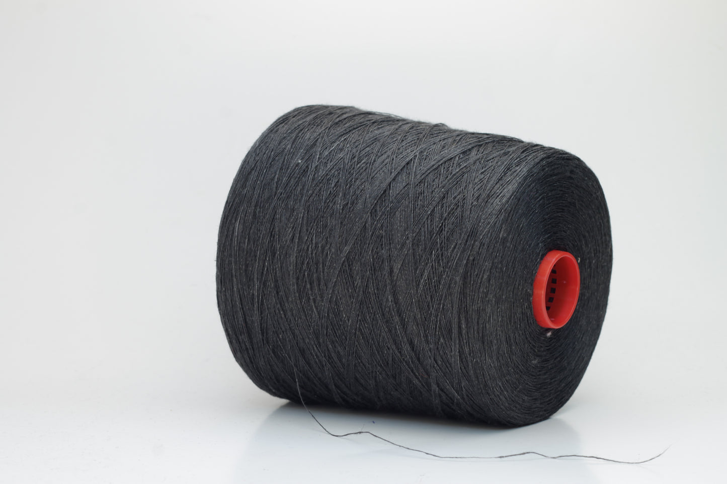 Fine, single-ply linen yarn in a rich Charcoal Black. Reveals a crisp texture and subtle natural sheen, typical of pure linen fiber.