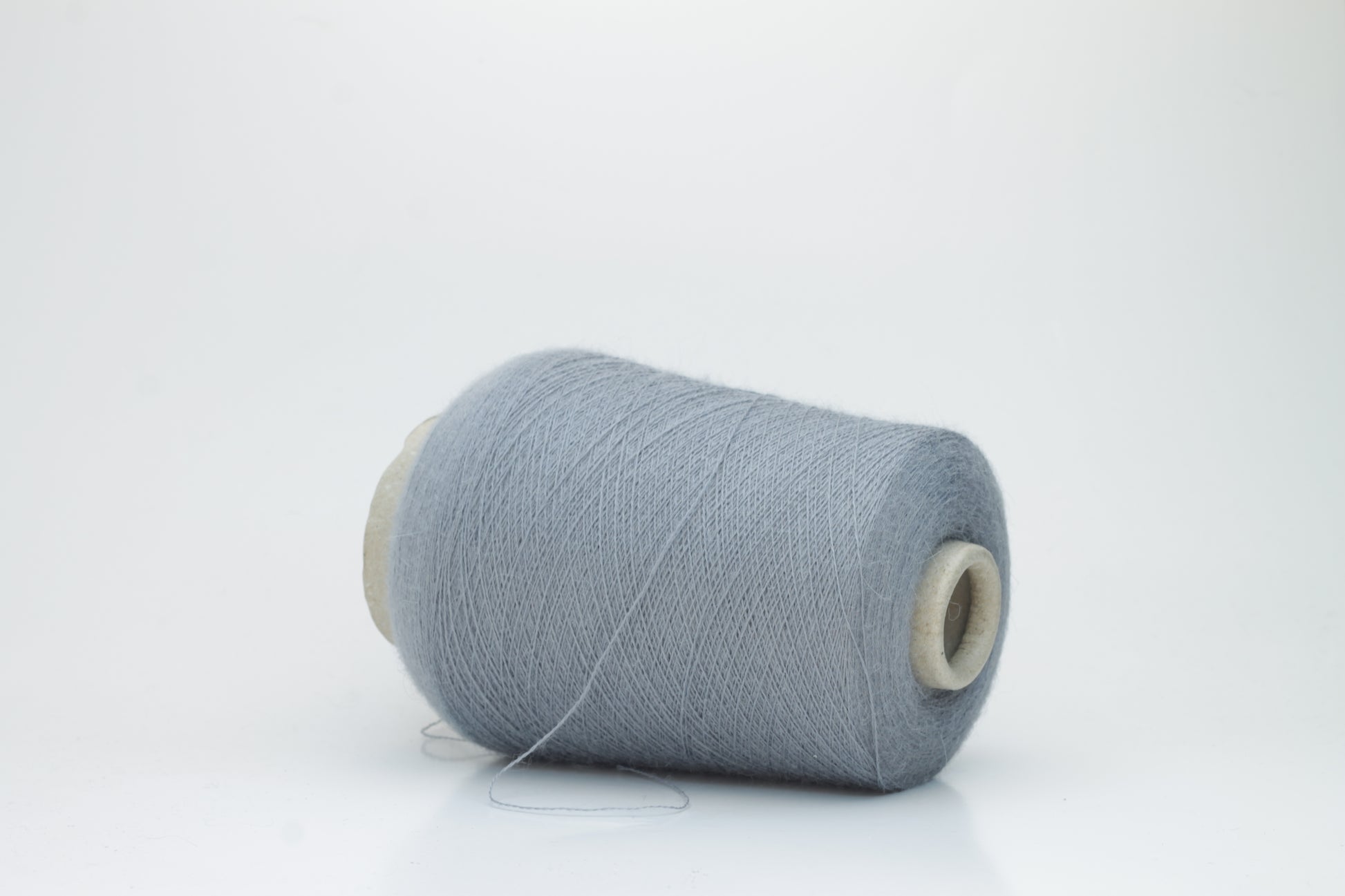 Denim Blue 2-ply Alpaca Merino yarn, softly twisted with a gentle halo and subtle sheen, showcasing its deep, luxurious color saturation.