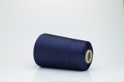 Close-up of finely spun navy blue silk yarn, gently twisted, displaying a subtle, elegant sheen. Smooth, lustrous fibers reflect light softly, hinting at fluid drape and rich color depth.