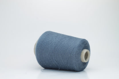 Close-up of a skein of soft, plied alpaca merino yarn in a deep Blue, showing subtle sheen and fine fiber halo.