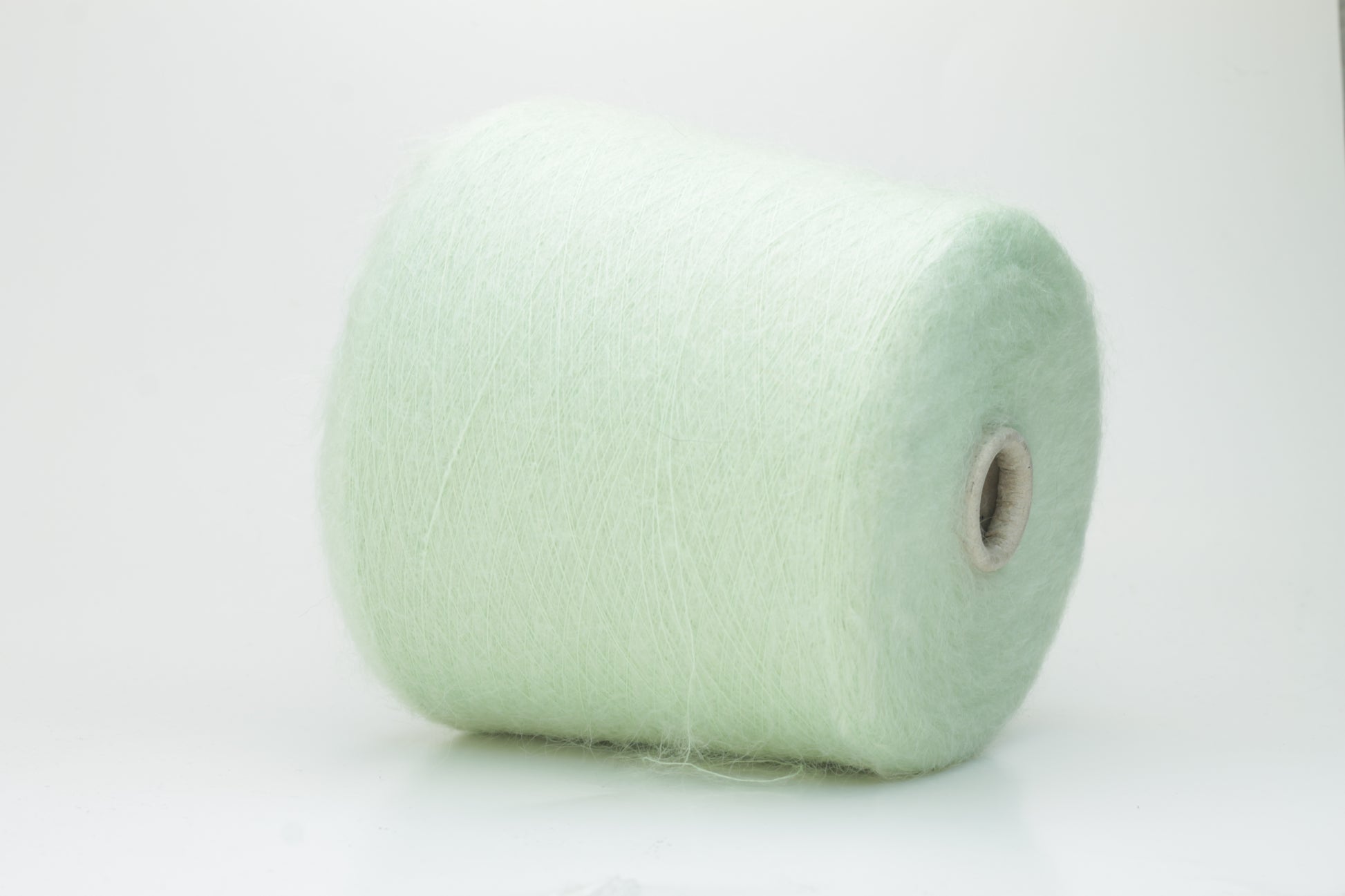 Close-up view of Light Green SuperKidMohair yarn showing a dense, fluffy pile structure and subtle sheen. The yarn has a uniform ply twist with a rich color depth.
