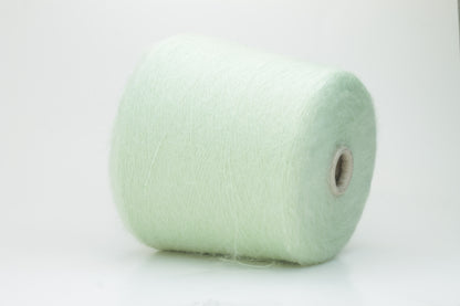 Close-up view of Light Green SuperKidMohair yarn showing a dense, fluffy pile structure and subtle sheen. The yarn has a uniform ply twist with a rich color depth.