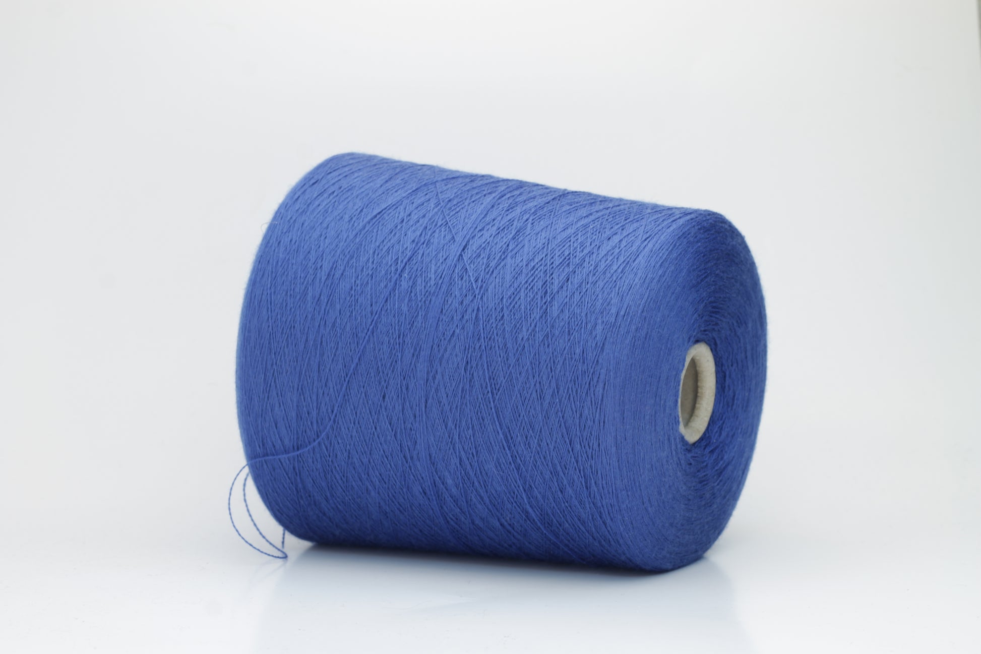 Close-up of luxurious petrol blue Merino wool yarn, two-ply twist with a soft, subtle sheen, and fine, consistent thread structure.