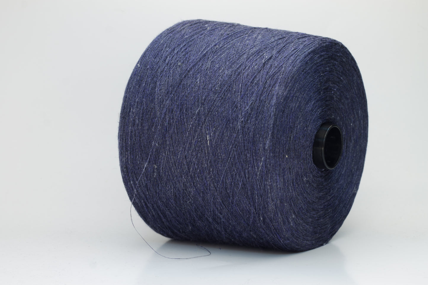Fine, single-ply linen yarn in a rich Navy Blue. Reveals a crisp texture and subtle natural sheen, typical of pure linen fiber.