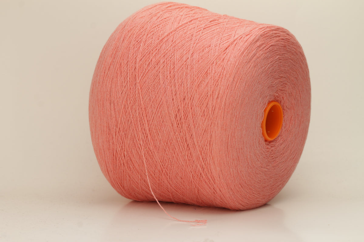 Close-up of soft, two-ply cashmere yarn in a delicate, even pink shade, showcasing its fine, slightly fuzzy texture and subtle sheen.