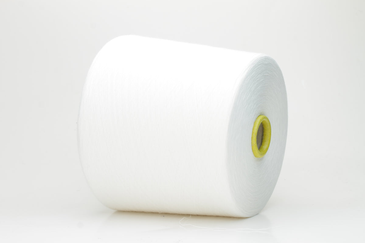 Close-up of a tightly wound, pure white skein of Loro Piana combed cotton yarn. It has a smooth, uniform texture and a subtle, elegant sheen.