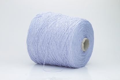 Close-up of a skein of soft, nubby Serenity blue bourette silk yarn. Its matte finish and subtle slubs reveal a raw, natural texture.