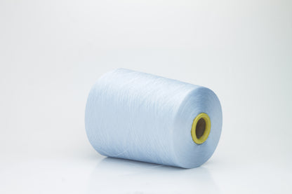 Close-up of radiant Azzurro blue silk yarn, featuring a finely spun, lustrous organzino thread with a pronounced, smooth sheen.