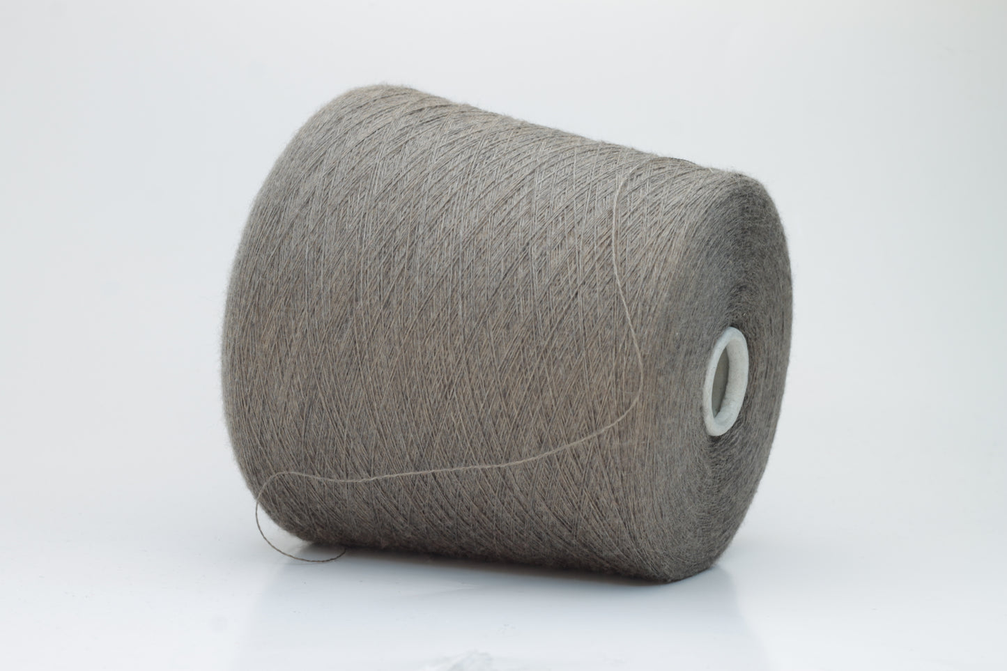 Close-up shot of Zegna Baruffa Merino 100% Cashwool Yarn in Taupe, showcasing a dense ply twist and fine thread structure with subtle sheen and a fluffy texture.
