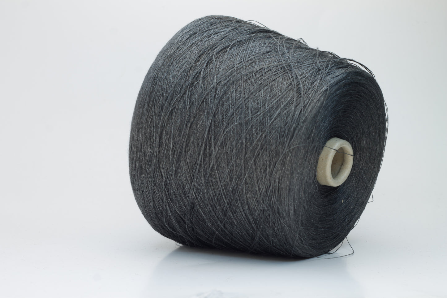 Close-up of a neatly wound skein of fine, smooth brownish-grey linen yarn, exhibiting subtle natural slub variations and a gentle matte sheen.
