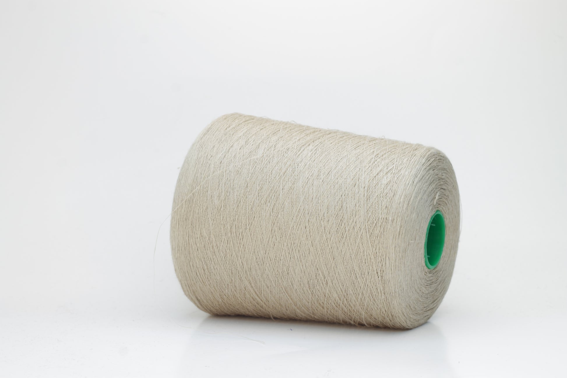 Fine, single-ply linen yarn in a rich Oatmeal. Reveals a crisp texture and subtle natural sheen, typical of pure linen fiber.