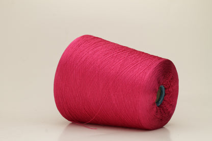 Close-up of vibrant hot pink 100% pure silk yarn, showcasing its fine, smooth single ply and high, natural luster reflecting light beautifully.
