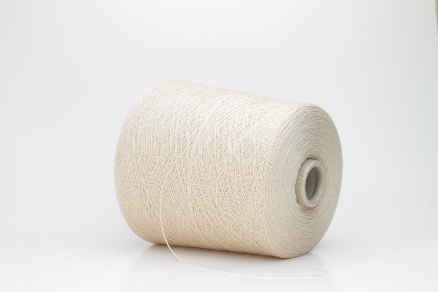 Close-up of luxurious Beige Merino wool yarn, two-ply twist with a soft, subtle sheen, and fine, consistent thread structure.