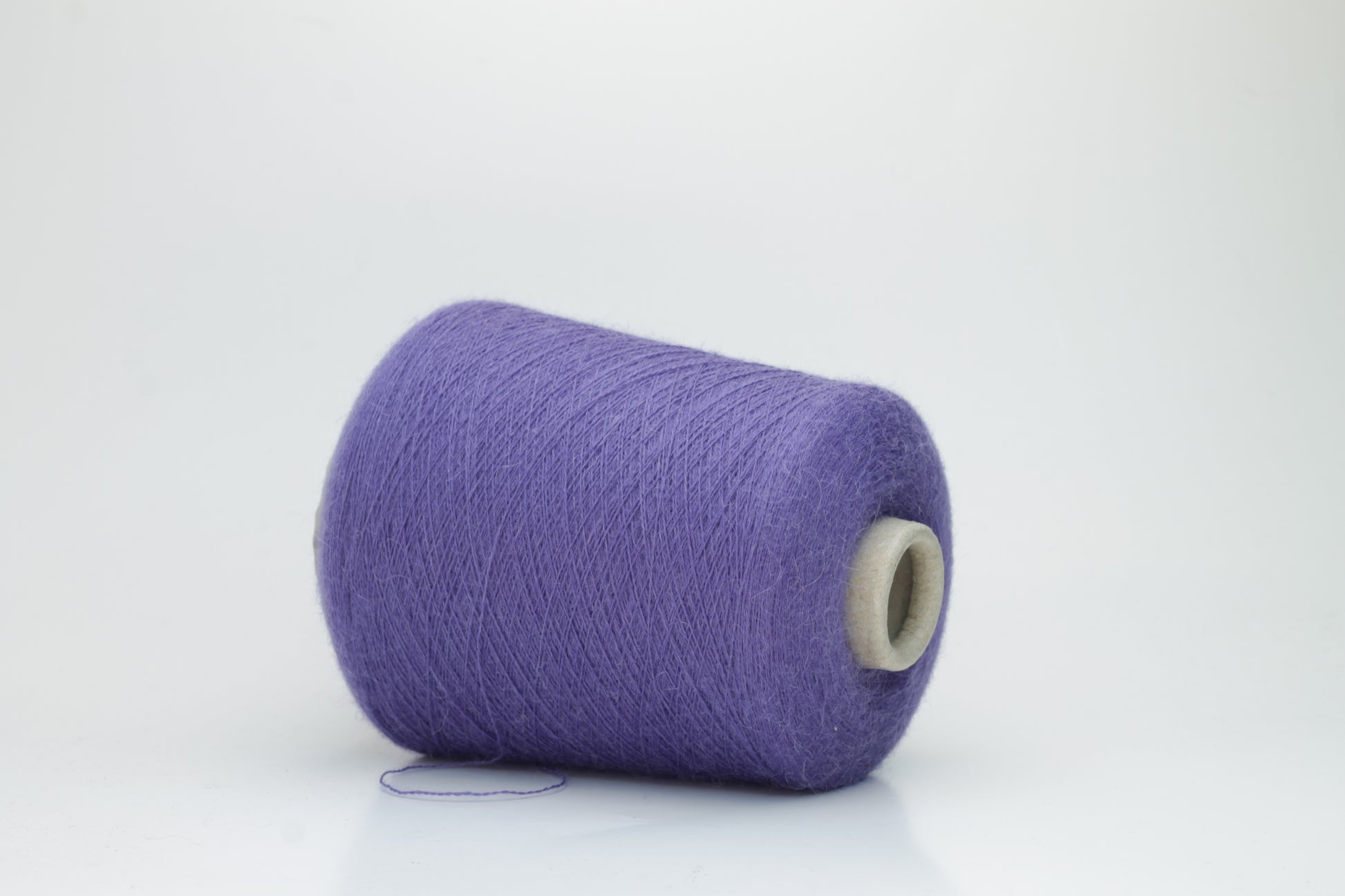 Rich purple 2-ply Alpaca Merino yarn, softly twisted with a gentle halo and subtle sheen, showcasing its deep, luxurious color saturation.