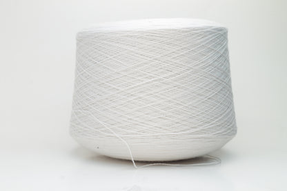 Close-up shot of creamy white Zegna Baruffa merino yarn, showcasing a dense, twisted ply structure and subtle sheen, with a fluffy texture inviting tactile exploration.