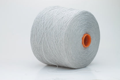 Close-up of a skein of luxurious, soft gray 100% cashmere yarn, featuring a gentle halo and a subtle, refined sheen. The two-ply structure is visible, showing even twist and consistent depth of the elegant cool gray color.