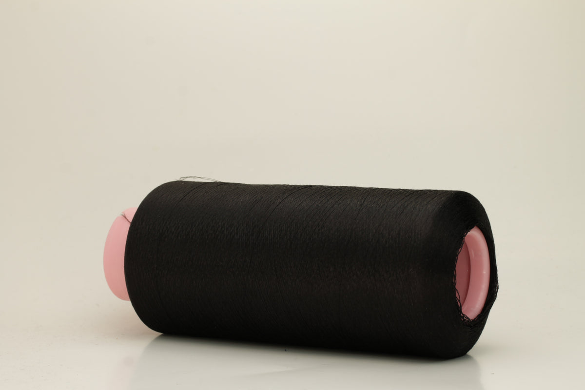 A skein of fine, single-ply 100% silk yarn, lustrous with a deep, rich Black hue, reflecting light softly.