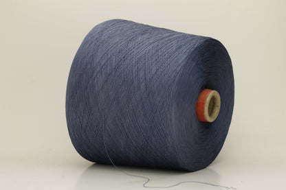 A tightly spun two-ply thread of very fine silk, exhibiting a deep, rich indigo blue hue with a natural, subtle shimmer under light.