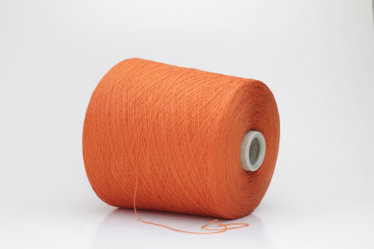Close-up of luxurious Cognac Merino wool yarn, two-ply twist with a soft, subtle sheen, and fine, consistent thread structure.