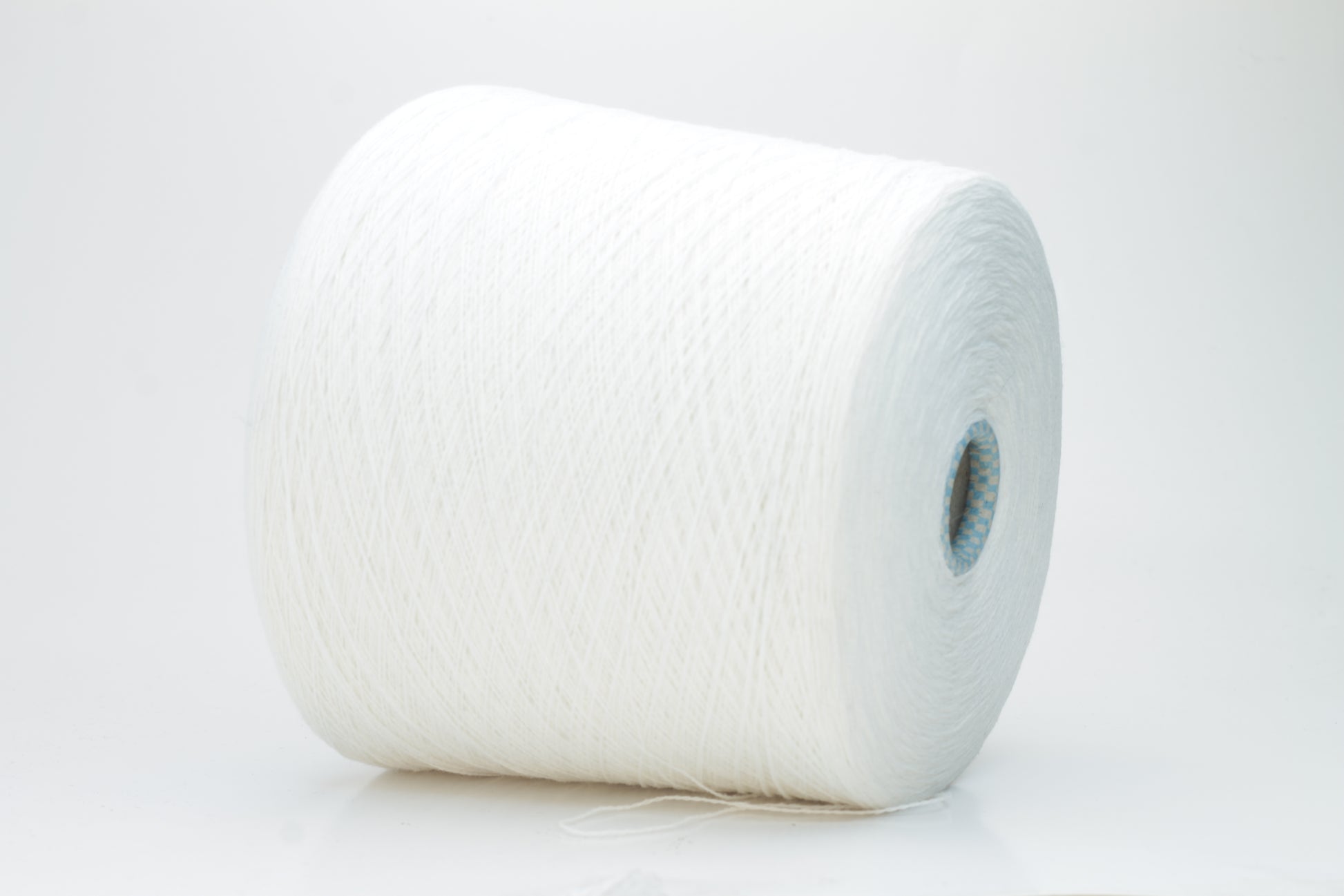 Close-up of a luxurious, soft skein of pale, milky blue cashmere yarn with a subtle sheen and light, even two-ply twist.