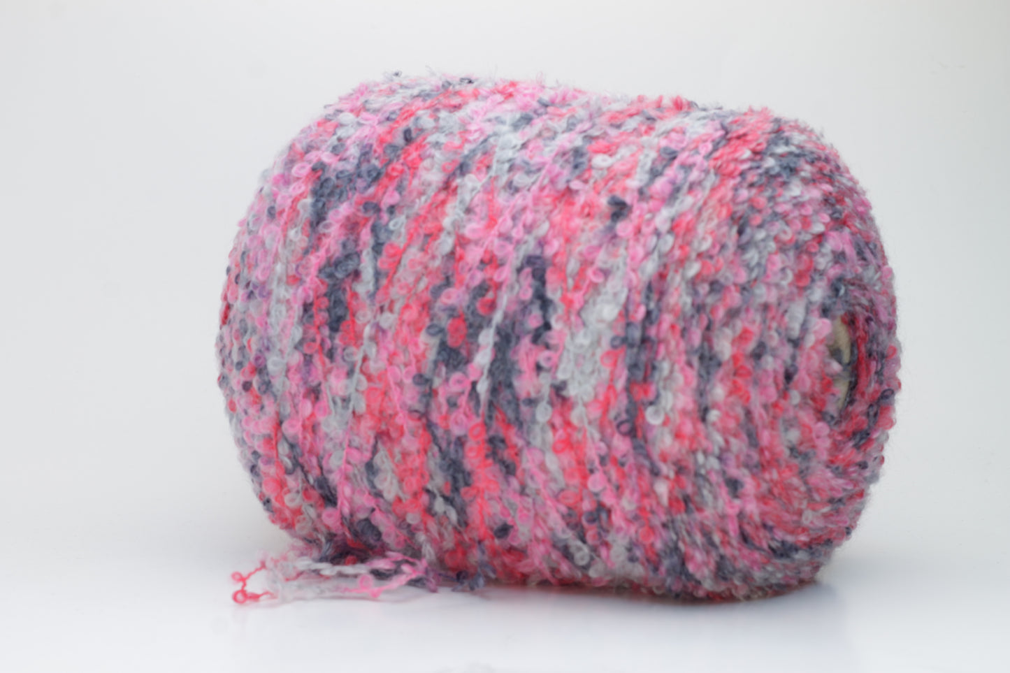 Close-up shot of multicolored SuperKidMohair yarn, showcasing its fluffy texture, slight sheen, and tight ply twist – a rich blend ready for knitting or weaving.