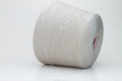 Close-up shot of a vibrant, creamy beige merino yarn skein, showcasing its subtle sheen, delicate ply twist, and the fine, soft texture of the fibers.