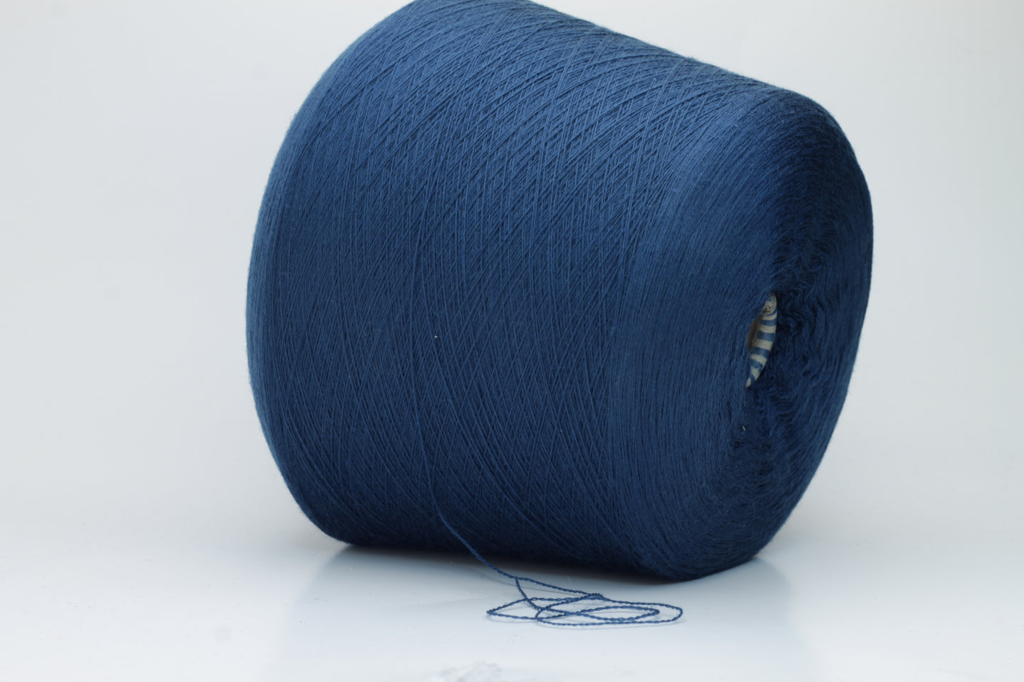 Close-up view of ZEGNA BARUFFA Merino 100% Cashwool, Nm 2/30, Color Blue. The yarn showcases a tight, even ply twist with a dense thread structure and subtle sheen reflecting the deep blue color, presenting a fluffy and inviting texture.