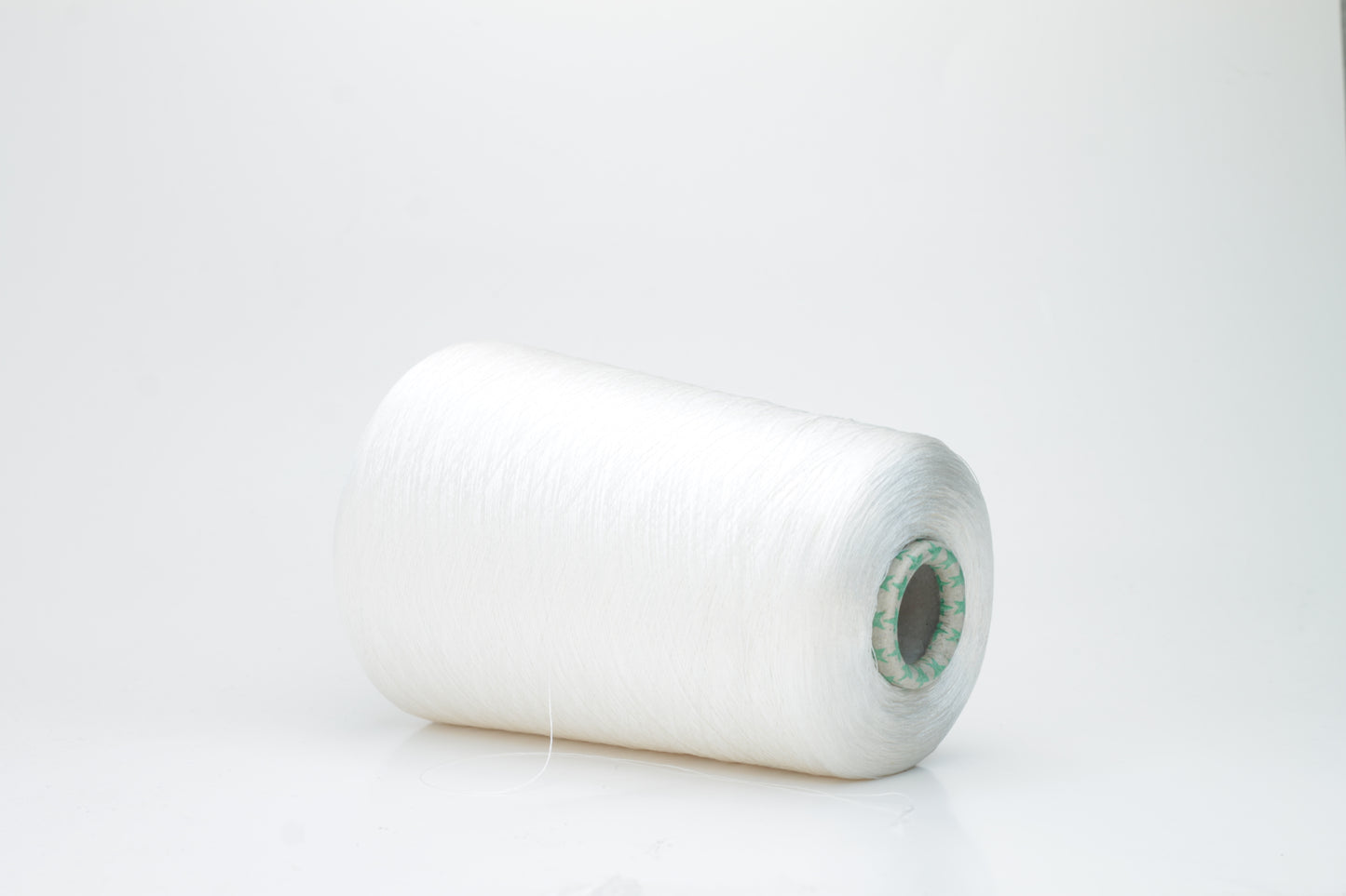 Close-up of brilliant white 100% silk yarn, single-ply strand with a smooth, highly lustrous surface, softly draped. Shimmering.