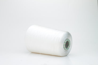 Close-up of brilliant white 100% silk yarn, single-ply strand with a smooth, highly lustrous surface, softly draped. Shimmering.