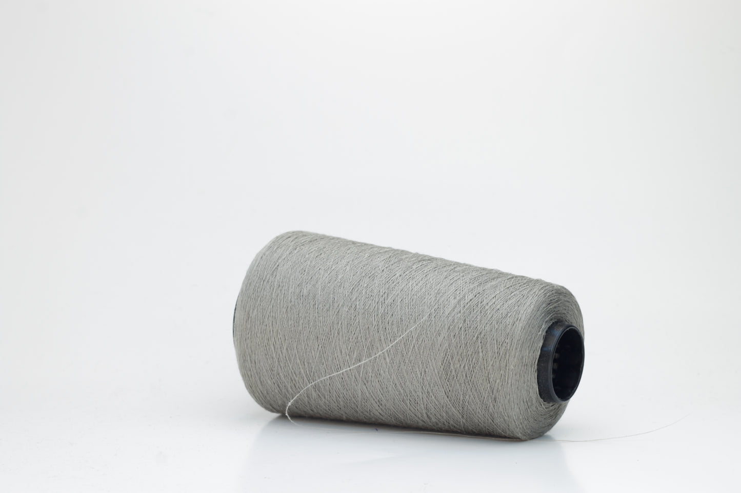 Fine, single-ply linen yarn in a rich Silver Gray. Reveals a crisp texture and subtle natural sheen, typical of pure linen fiber.
