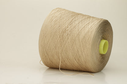 Close-up of a single strand of lustrous, fine-gauge beige silk and cotton yarn, showcasing its smooth, even twist and soft sheen.