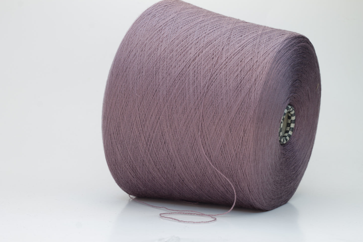 Close-up shot of Zegna Baruffa Merino 100% Cashwool yarn in color 438 Ninfea, showcasing the fine ply twist and rich, deep hue of the fibers.
