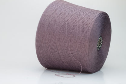 Close-up shot of Zegna Baruffa Merino 100% Cashwool yarn in color 438 Ninfea, showcasing the fine ply twist and rich, deep hue of the fibers.