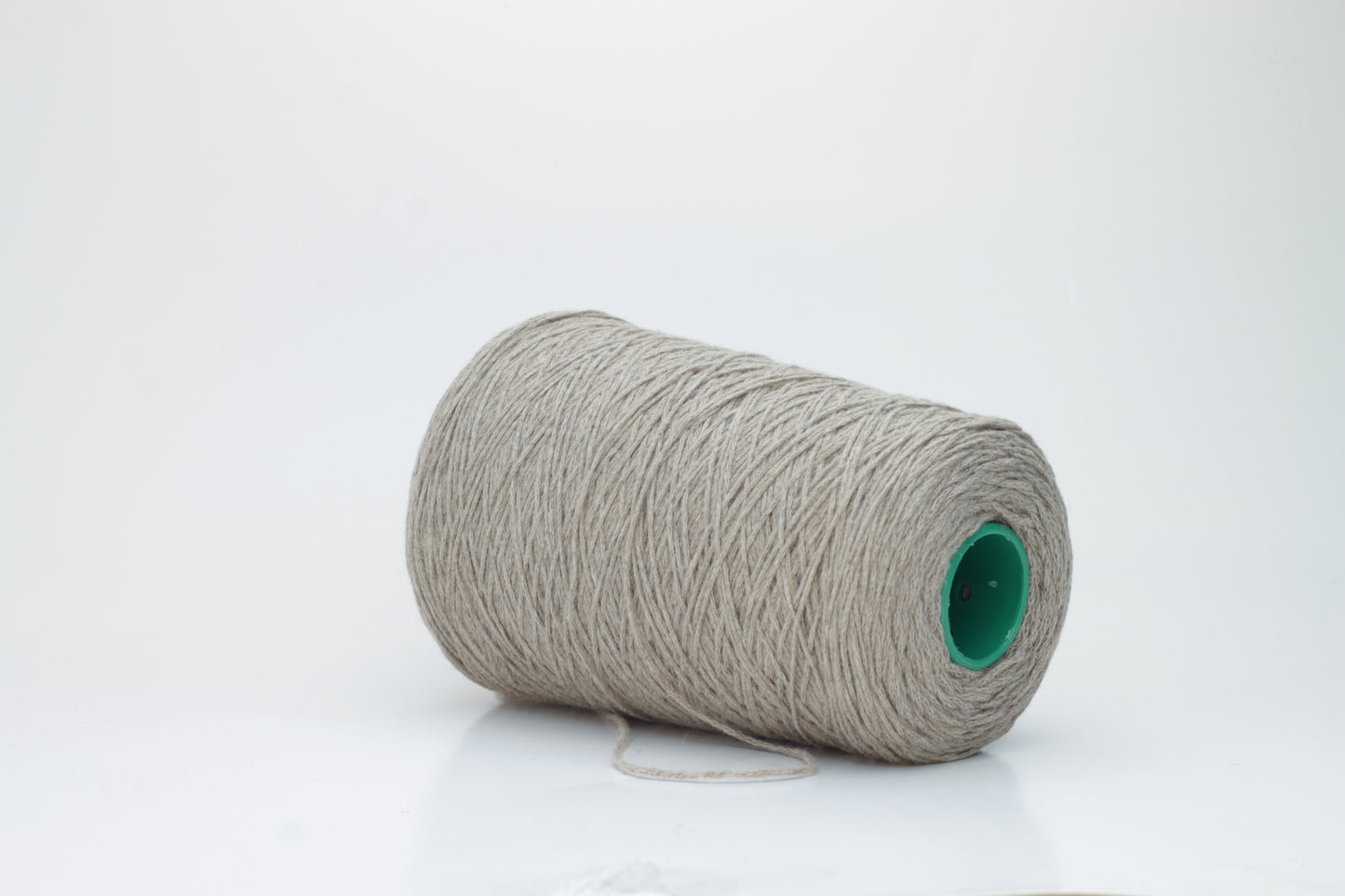 A finely spun, single-ply cashmere yarn in a rich, warm squirrel-brown, exhibiting a delicate halo of soft fibers and a subtle, natural sheen.